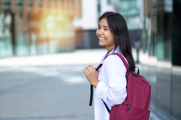 Happy smiling asian woman, female student going to study at university. Copy Space