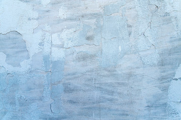 A blue old wall of loose plaster. Abstract background.