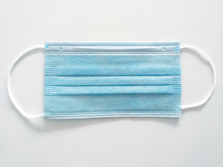Aerial view of a non-sterile surgical mask with a high level of protection against viruses and pandemics. Comfortable sanitary product with latex-free rubber bands. Sanitary material close up.