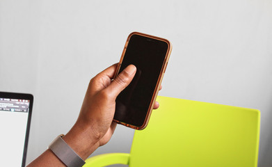 Black male African hand holding a cellphone mobile device 