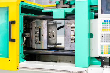 metal mould or plastic injection mold setup on high pressure injection molding machine for mass...