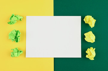 White piece of paper on a yellow-green background