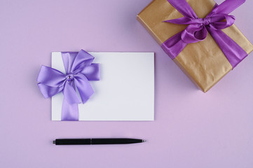 gift card with purple bow gift wrapping on purple background