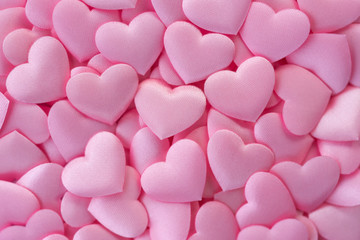 Pink satin hearts background. Love pink background. Top view