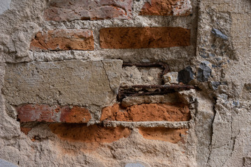 An old broken brick wall saw a steel frame.