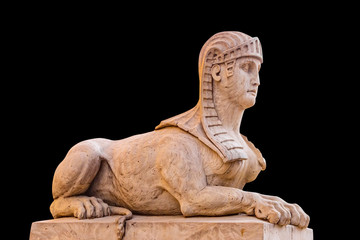 Old sphinx statue on black background