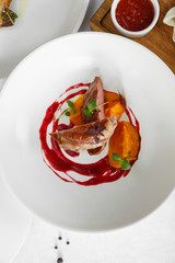 Duck breast with vegetables. Delicious healthy roasted duck fillet food closeup served on a table.