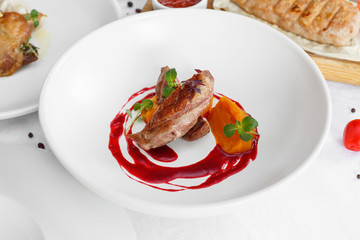 Duck breast with vegetables. Delicious healthy roasted duck fillet food closeup served on a table.