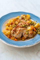 Chicken Thighs with Potato, Carrot and Green Peas served in Plate for One Portion