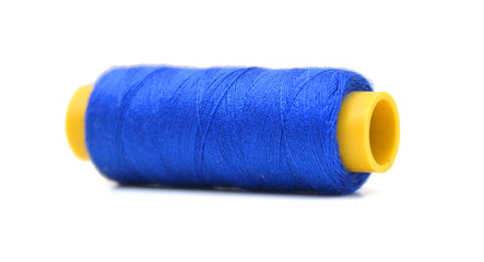 Spool of coloured thread isolated on white background. 