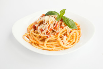 Closeup on italian pasta with tomato sauce and parmesan in the plate on the white surface