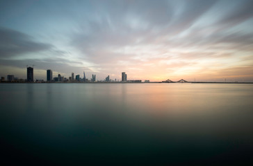 Fototapeta premium Bahrain skyline with beautiful clouds during sunset