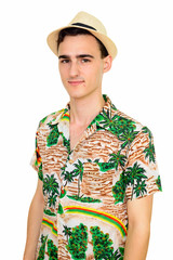Studio shot of young handsome Caucasian man wearing Hawaiian shirt isolated against white background