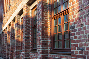 Brick wall with big windows from a side perspective.