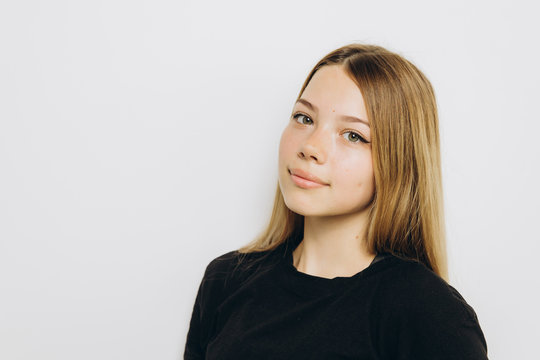 A teenage girl against grey background with copy space