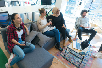 Startup Marketing Idea Presentation. Group of Young multiethnic Coworkers Making Great Business Decisions. Creative Team Discussion Corporate Work Concept inside Modern Office.