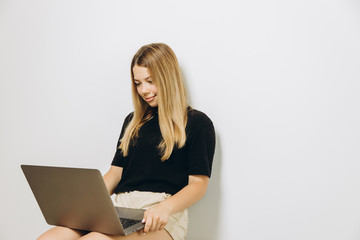 A teenage girl with a notebook against grey background