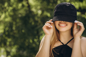 A teenage girl is having a walk in a green city park