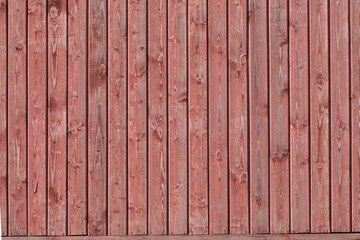 Background of rough vertical old red wooden boards