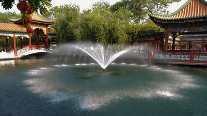 fountain in the pond among the pavilions of Chinese architecture in Baomo Park, Guangzhou China