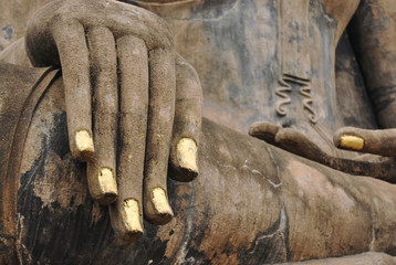 Hand of an ancient Buddha statue in Wat Mahathat temple. Golden nails. Thailand, Sukhothai, 