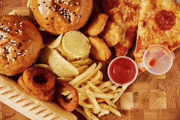 Unhealthy and junk food. Different types of fast food on the table, closeup