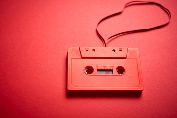 old red cassette tape on a minimalist background