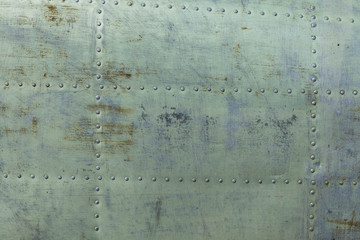 background of the fuselage of the aircraft. Yellow-green metal surface asscelled