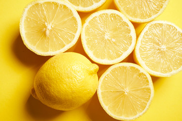 fresh lemons on a yellow minimalistic background