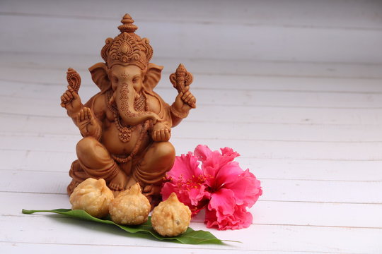 Indian Food: Idol of lord Ganesha with modak Maharashtra Sweet Dish, greeting card. Ganesh chaturthi