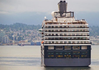 Stern of HAL or Holland America cruiseship or cruise ship liner against skyline of Vancouver,...