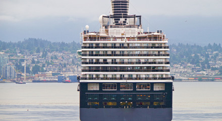 Stern of HAL or Holland America cruiseship or cruise ship liner against skyline of Vancouver,...