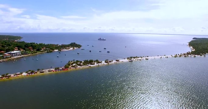 Aerial view of a cruise anchored in Alter do Chao, incredible vacation destination in the Amazon basin in Brazil. Here the river is so big that it looks like the sea