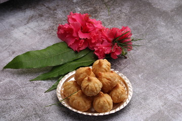 Ganesh Puja - Sweet Modak food offered on Ganpati festival or Chaturthi in India. served in silver plate.