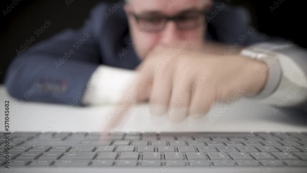 Poster funny inexperienced businessman types with one finger on the computer keyboard, being beginner conce