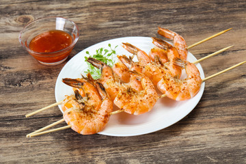 Grilled prawn skewer with sauce