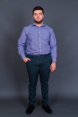 Obraz premium Portrait of young handsome overweight bearded businessman