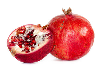Ripe pomegranate fruits with juicy grains on a white background. Close-up.
