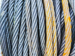 Detail of electrical power cable on the reel. Roll of metal wire of silver color.