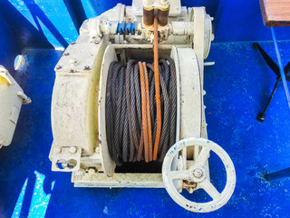 Detail of electrical power cable on the reel. Roll of metal wire of silver color.