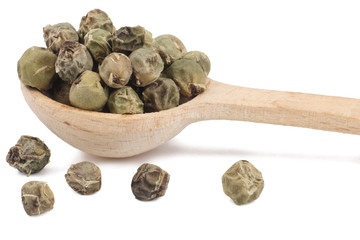 Green pepper peas in the wooden spoon isolated on white