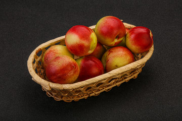 Sweet small nectarines in the basket