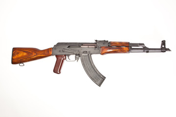 AK-47 with a magazine inserted on white background.