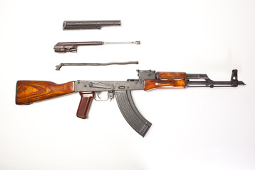Parts of an AK-47 displayed on a white background.