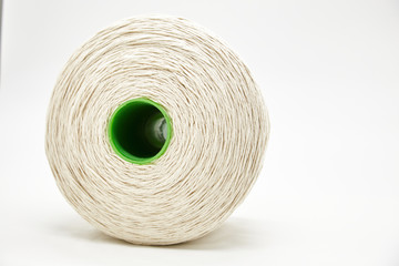 A large white coil with a coiled rope, isolated on a white background. Large cord, rope, thread is used for handmade sausages.