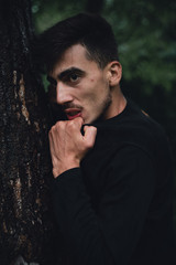 Young man protecting the forest trees, nature and people concept