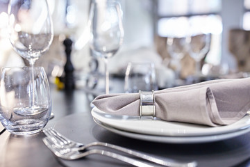 Wedding table set for dinner. Beautiful table setting with cutlery, purple napkin and plate. Top view. 