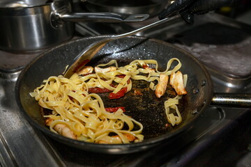 Cooking pasta with red fish and sun-dried tomato