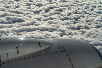 Fototapeta na wymiar engine and wing of aircraft on background of cloud