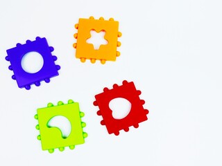 Colorful children's sorter. Toy shapes isolated on a white background. The sorter is of cubical shape. Children's brain training. Geometry, games